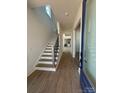 Open entryway features a staircase with wood treads and black metal railing, leading to the upper level at 7392 Deer Hollow Rd # 27, Sherrills Ford, NC 28673
