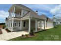 Rear view of a home showcasing a covered patio, pillars, and manicured lawn at 7392 Deer Hollow Rd # 27, Sherrills Ford, NC 28673
