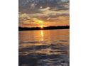 A stunning view of a lake at sunset, casting vibrant orange and yellow hues across the water at 7831 Spinnaker Bay Dr # 314, Sherrills Ford, NC 28673