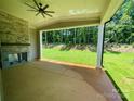 Relaxing covered patio with stone fireplace and ceiling fan overlooking the private backyard at 2007 Kendall Dr # 6, Wesley Chapel, NC 28173