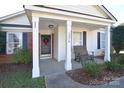Inviting front porch with seating area perfect for relaxing and enjoying the outdoors at 3076 Champion Sw Ln, Concord, NC 28025