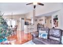 Open-concept living room featuring hardwood floors and seamlessly connecting to the kitchen and dining areas at 3076 Champion Sw Ln, Concord, NC 28025