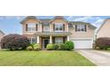 Charming two-story home with a stone facade, well-manicured lawn, and attached two-car garage at 11005 Magna Ln, Indian Trail, NC 28079