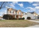 Inviting two-story home featuring neutral siding, well-kept lawn, and landscaping in a suburban neighborhood at 11005 Magna Ln, Indian Trail, NC 28079