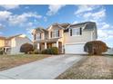 Beautiful two-story home with a well-manicured lawn, a two-car garage, and a welcoming driveway at 11005 Magna Ln, Indian Trail, NC 28079