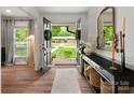 Inviting foyer with hardwood floors, console table, and view to front yard at 1102 Oak Hill Dr, Monroe, NC 28112