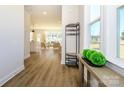 Inviting foyer featuring wood-look floors, stylish decor, and a view into the open-concept living space at 165 Halite Ln, Waxhaw, NC 28173