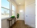 Bright and airy entryway boasts wood-look floors, ample natural light, and a convenient coat closet at 165 Halite Ln, Waxhaw, NC 28173