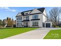 Striking Modern Farmhouse with verdant lawn, long driveway and attached two-car garage at 1015 Kendall Dr # 4, Wesley Chapel, NC 28173