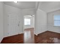 Bright entryway with hardwood floors, leading to a living room and dining area at 10436 Paisley Abbey Ln, Charlotte, NC 28273