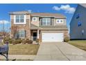 Two-story house with stone and siding accents, two-car garage, and landscaped lawn at 10436 Paisley Abbey Ln, Charlotte, NC 28273