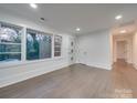 Hardwood floor living room with neutral walls and a view to backyard at 1330 Mulberry Ave, Charlotte, NC 28216