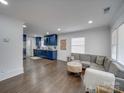 Open living room with hardwood floors and gray sectional sofa at 1330 Mulberry Ave, Charlotte, NC 28216