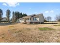 House exterior showcasing a side view and lawn at 135 Rumple Hill Dr, Statesville, NC 28677