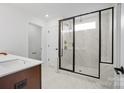 Bathroom with walk-in shower, marble tile, and modern fixtures at 13732 Roderick Dr # 170, Huntersville, NC 28078