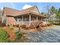 Inviting brick home with a charming covered porch, perfect for relaxing outdoors at 158 White Rd, Wadesboro, NC 28170