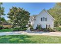 White brick home with manicured lawn and charming landscaping at 19100 Mary Ardrey Cir, Cornelius, NC 28031