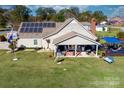 Aerial view showcases home's layout, backyard, and solar panels at 303 Knox St, Clover, SC 29710