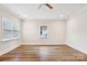 Empty bedroom boasts wood-look floors, neutral walls, and natural light from two windows at 309 S Ransom St, Gastonia, NC 28052