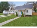 Charming single-story home with a blue front door, well-maintained lawn, and inviting curb appeal at 309 S Ransom St, Gastonia, NC 28052