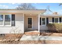 Close-up of the home's entry featuring a covered front porch with decorative columns and a brick foundation at 440 Providence Rd, Lancaster, SC 29720