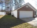 Brick home with attached garage and AC unit at 8027 Bristle Ln, Charlotte, NC 28214