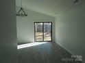 Bright living room with sliding glass doors and chandelier at 8027 Bristle Ln, Charlotte, NC 28214