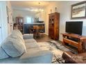 Open floor plan living and dining area with gray couch and wooden dining table at 112 Canina Ln, Indian Trail, NC 28079