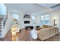 Open living area featuring hardwood floors, a fireplace, and comfortable seating at 1220 Lomax Ave, Charlotte, NC 28211