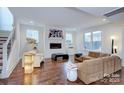 Bright living room with fireplace, hardwood floors, and modern furniture at 1220 Lomax Ave, Charlotte, NC 28211