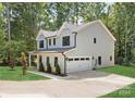 Two-story house with gray siding, a two-car garage, and landscaping at 13114 Blacksmith Ct, Matthews, NC 28105