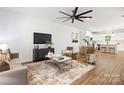 Open living room with hardwood floors, stylish furniture, and a view into the kitchen at 13114 Blacksmith Ct, Matthews, NC 28105