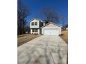 Charming two-story home with a spacious driveway and attached two-car garage at 1608 Cole St, Gastonia, NC 28054