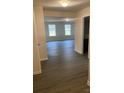 Bright hallway with wood-look flooring leading to a living room and other rooms at 1608 Cole St, Gastonia, NC 28054