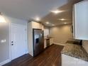 Modern kitchen with granite countertops, white cabinets, and stainless steel appliances at 1907 Steele St, Monroe, NC 28110