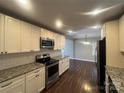 Well-equipped kitchen featuring granite countertops, stainless appliances, and ample cabinet space at 1907 Steele St, Monroe, NC 28110