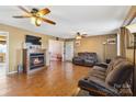 Spacious living room featuring a fireplace, hardwood floors, ceiling fans, and ample seating at 1976 Mcilwain Rd, Lancaster, SC 29720