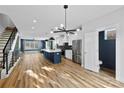 Spacious kitchen with stainless steel refrigerator, modern island, and an open floor plan at 327 Coxe Ave, Charlotte, NC 28208