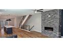 Bright, modern living room with hardwood floors, a fireplace, and open access to the kitchen at 327 Coxe Ave, Charlotte, NC 28208
