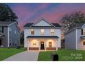 Two-story house with white siding, landscaping, and a driveway at 4039 Northerly Island Ct, Gastonia, NC 28056