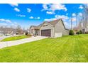 One-story home with a brown garage door and large yard at 423 Granite Lake Ct, Denver, NC 28037