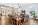 Bright living room features hardwood floors, comfortable seating, and plenty of natural light at 423 Granite Lake Ct, Denver, NC 28037