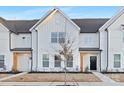 Up close new construction townhome with a black front door, light-colored wood beams, and a landscaped front yard at 444 Berryman Rd, Rock Hill, SC 29732