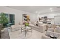 Bright, modern living room featuring a large sofa, stylish coffee table, and open layout to the kitchen at 444 Berryman Rd, Rock Hill, SC 29732