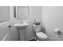 Clean powder room with pedestal sink and white toilet at 4551 Selhurst Dr, Indian Land, SC 29707