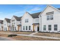 Exterior view of townhomes with white siding, black doors, and landscaped front yards at 456 Berryman Rd, Rock Hill, SC 29732