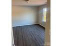 Spacious bedroom with grey laminate flooring and large window at 919 W Sumter St, Shelby, NC 28150