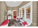 Inviting front porch with white wicker seating at 15175 Legend Oaks Ct, Fort Mill, SC 29707