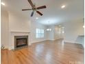 Spacious living room with hardwood floors, a fireplace, and a ceiling fan at 15334 S Birkdale Commons Pkwy, Huntersville, NC 28078