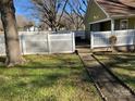 Landscaped backyard with a white fence and walkway at 506 S Love Chapel Rd, Stanfield, NC 28163